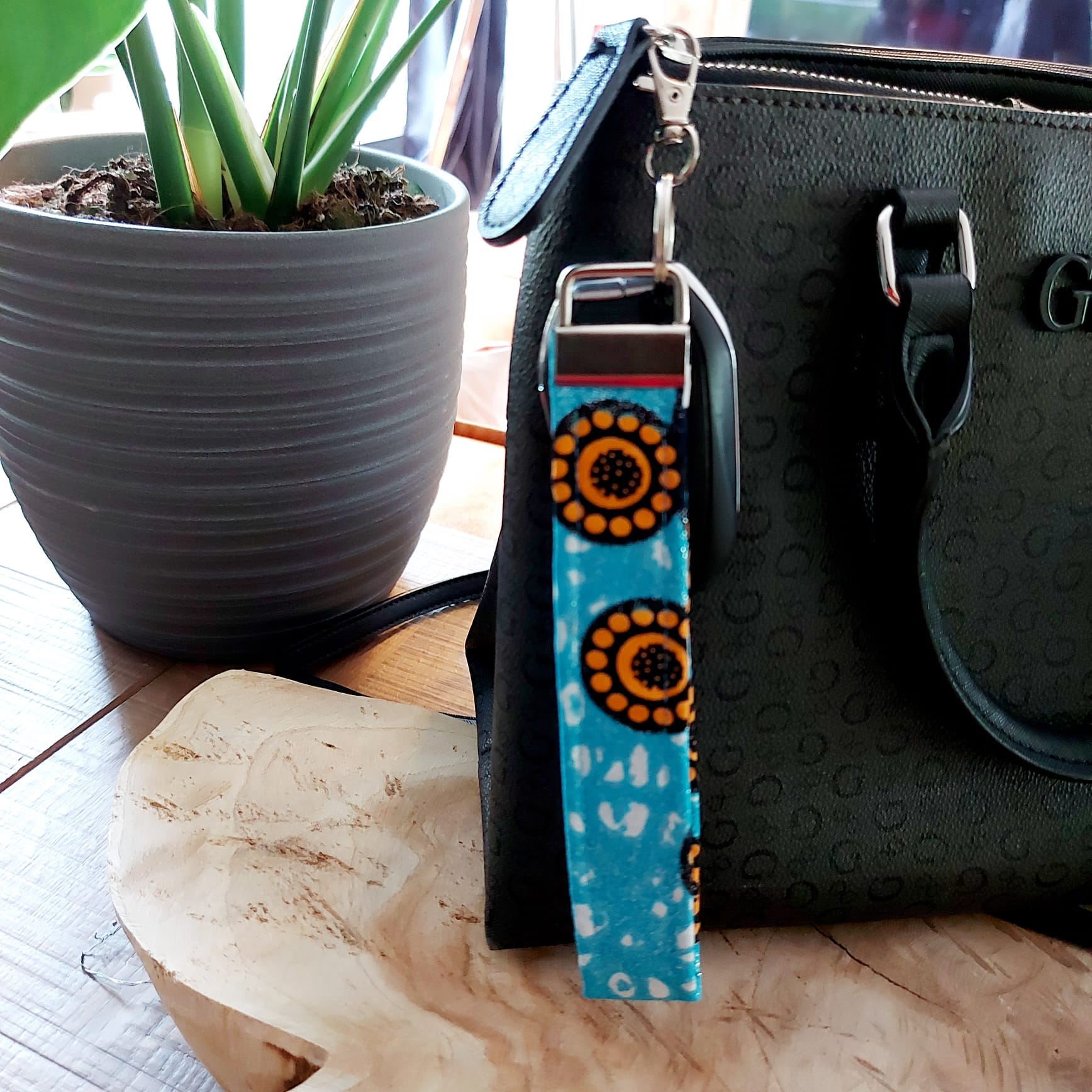 African Print and Leather Key Fob wristlet, showcasing vibrant fabric and sturdy vegan leather lining.