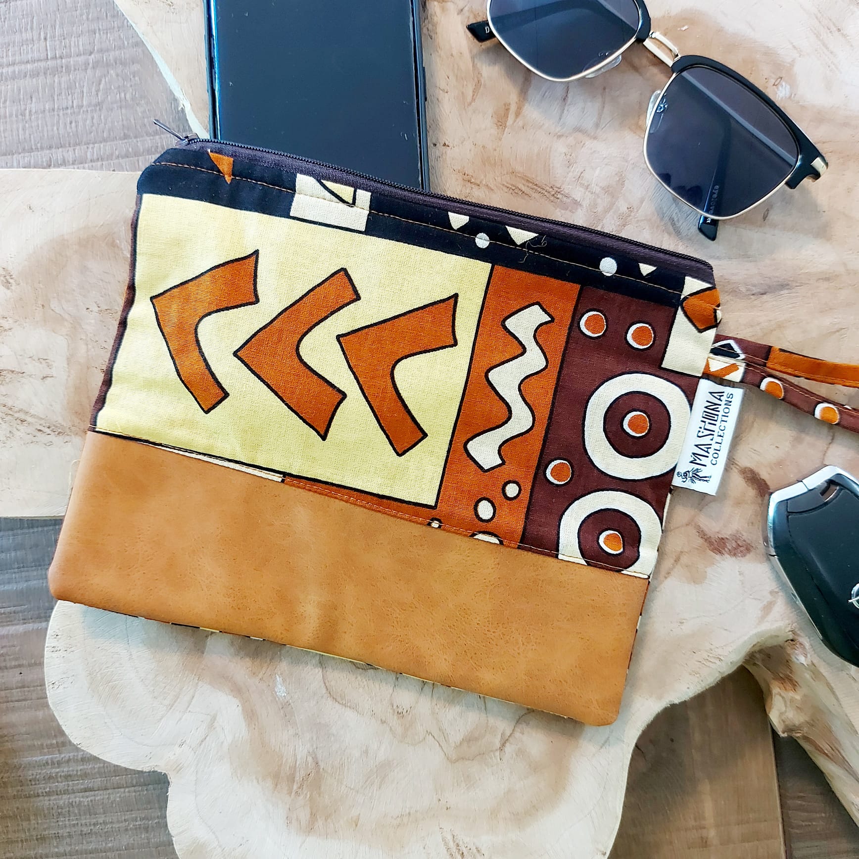 African Print Zipper Pouch made of vegan leather, featuring unique wax prints, perfect for make-up and stationery storage.