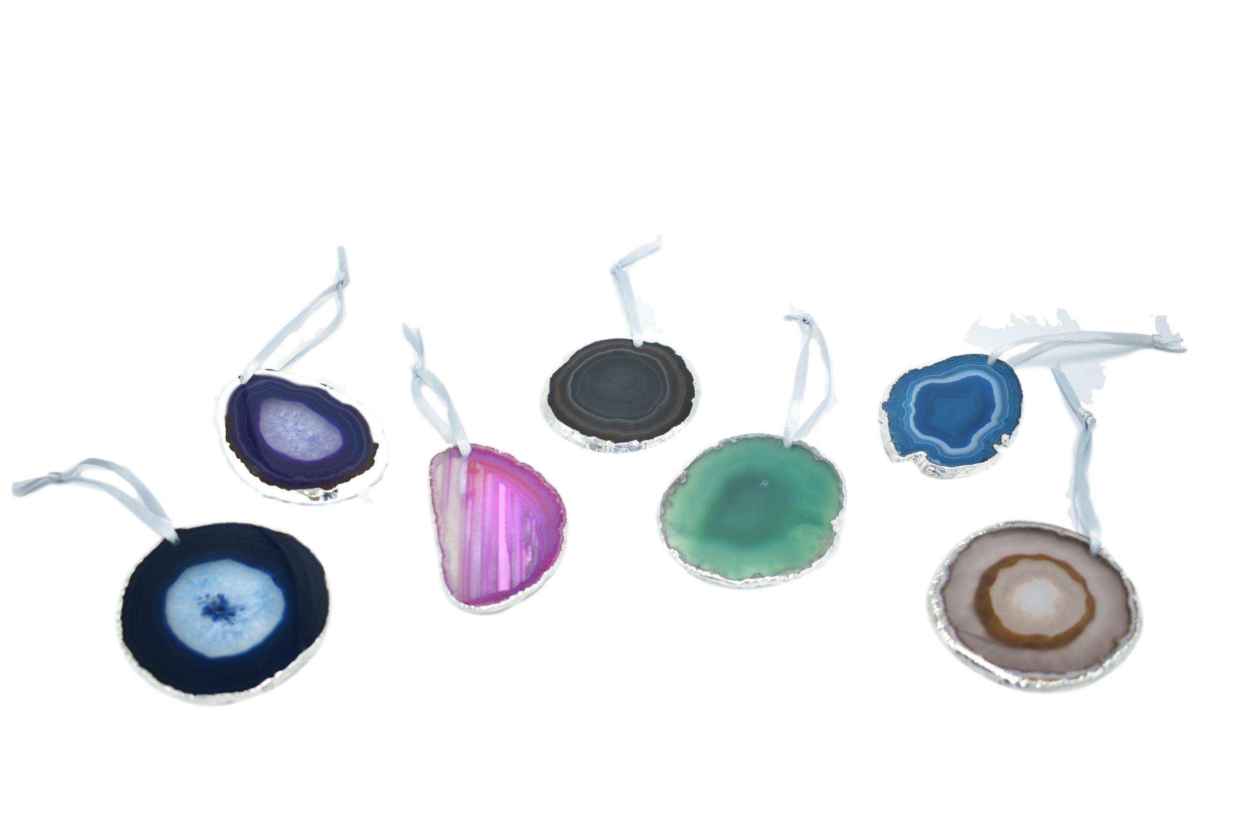 A beautiful agate ornament with silver electroplating, hanging from a silver silk ribbon, showcasing unique patterns and colors.