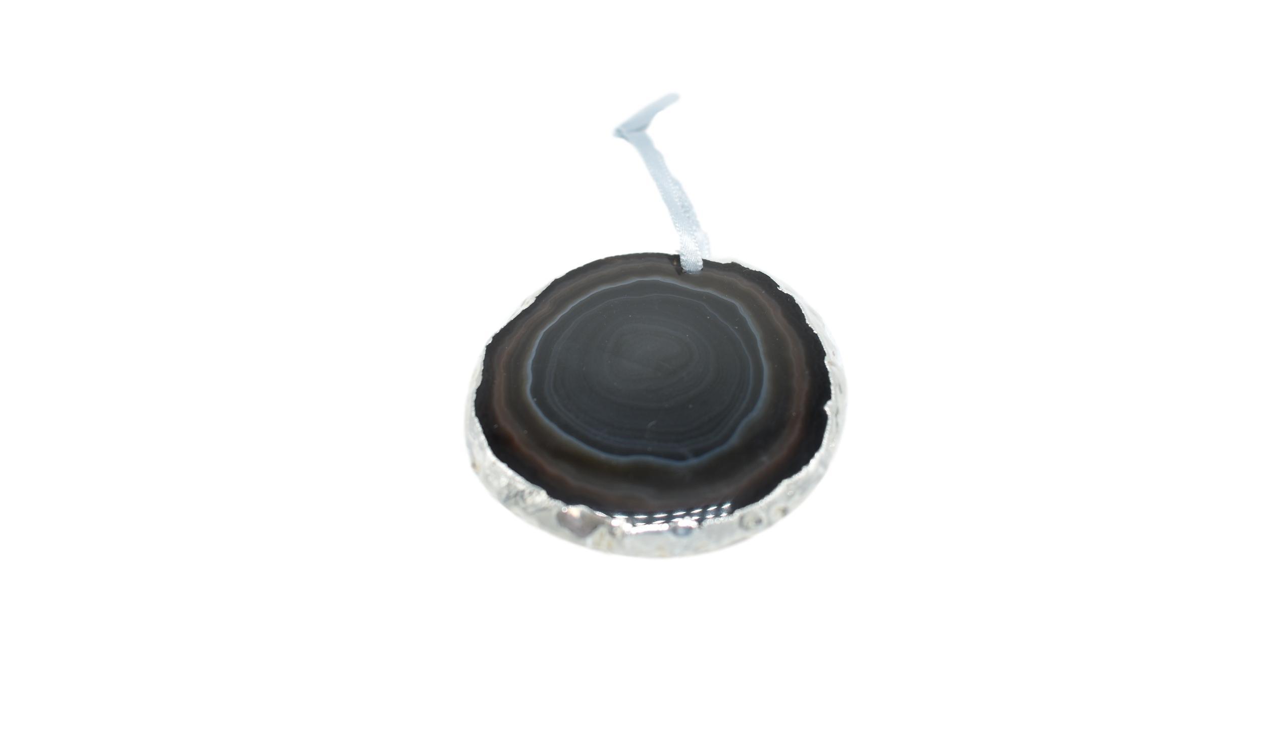 A beautiful agate ornament with silver electroplating, hanging from a silver silk ribbon, showcasing unique patterns and colors.