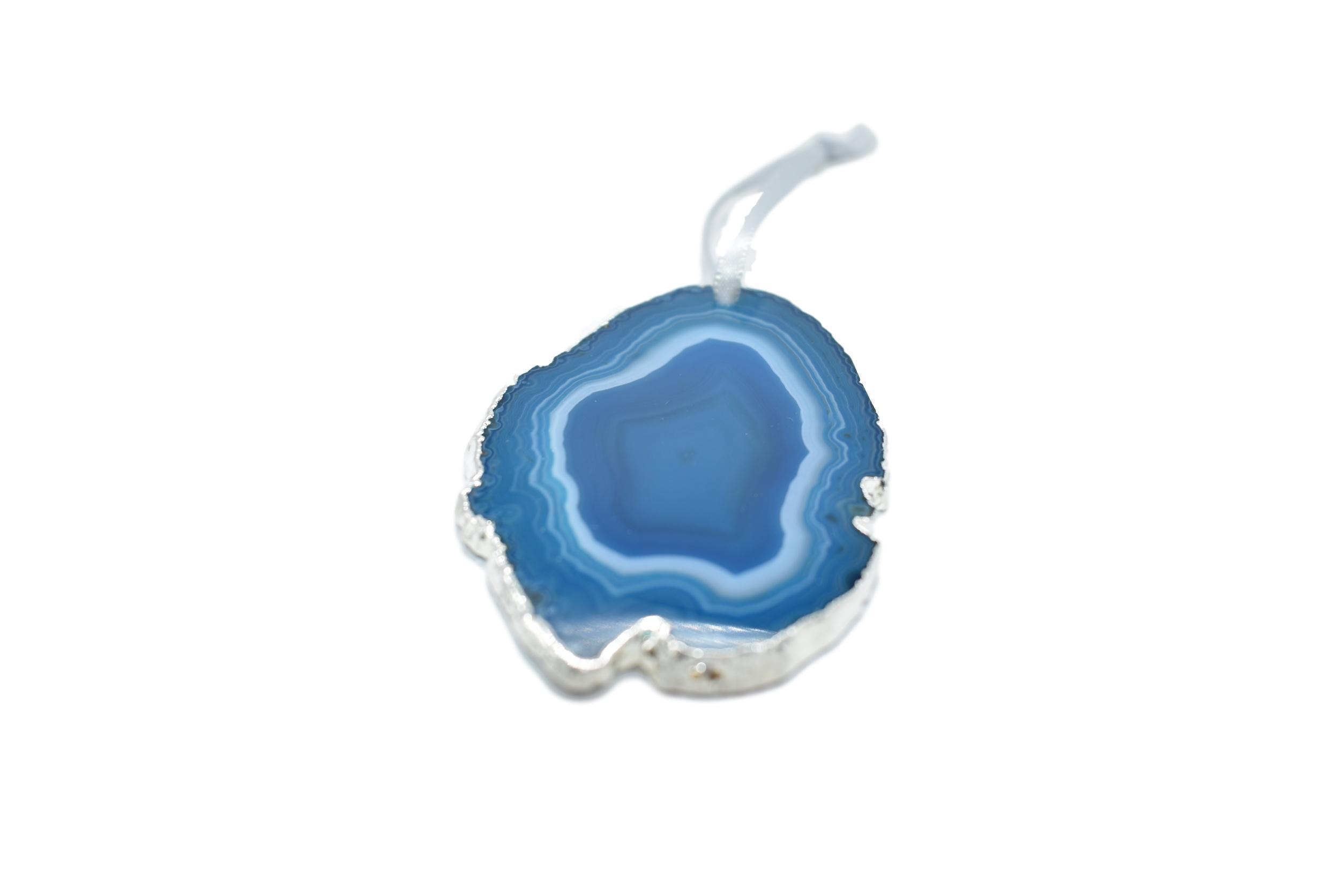 A beautiful agate ornament with silver electroplating, hanging from a silver silk ribbon, showcasing unique patterns and colors.