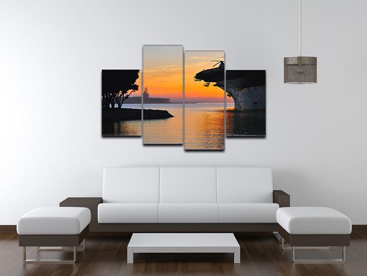 A beautiful 4-split canvas artwork depicting an aircraft carrier in a harbour during a vibrant sunset, showcasing rich colors and dynamic composition.