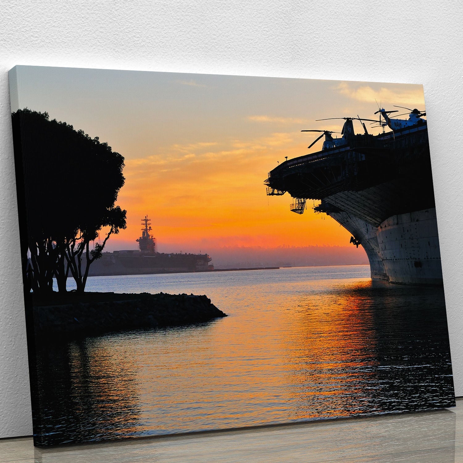A stunning canvas print of an aircraft carrier in a harbor during sunset, showcasing vibrant colors and intricate details.