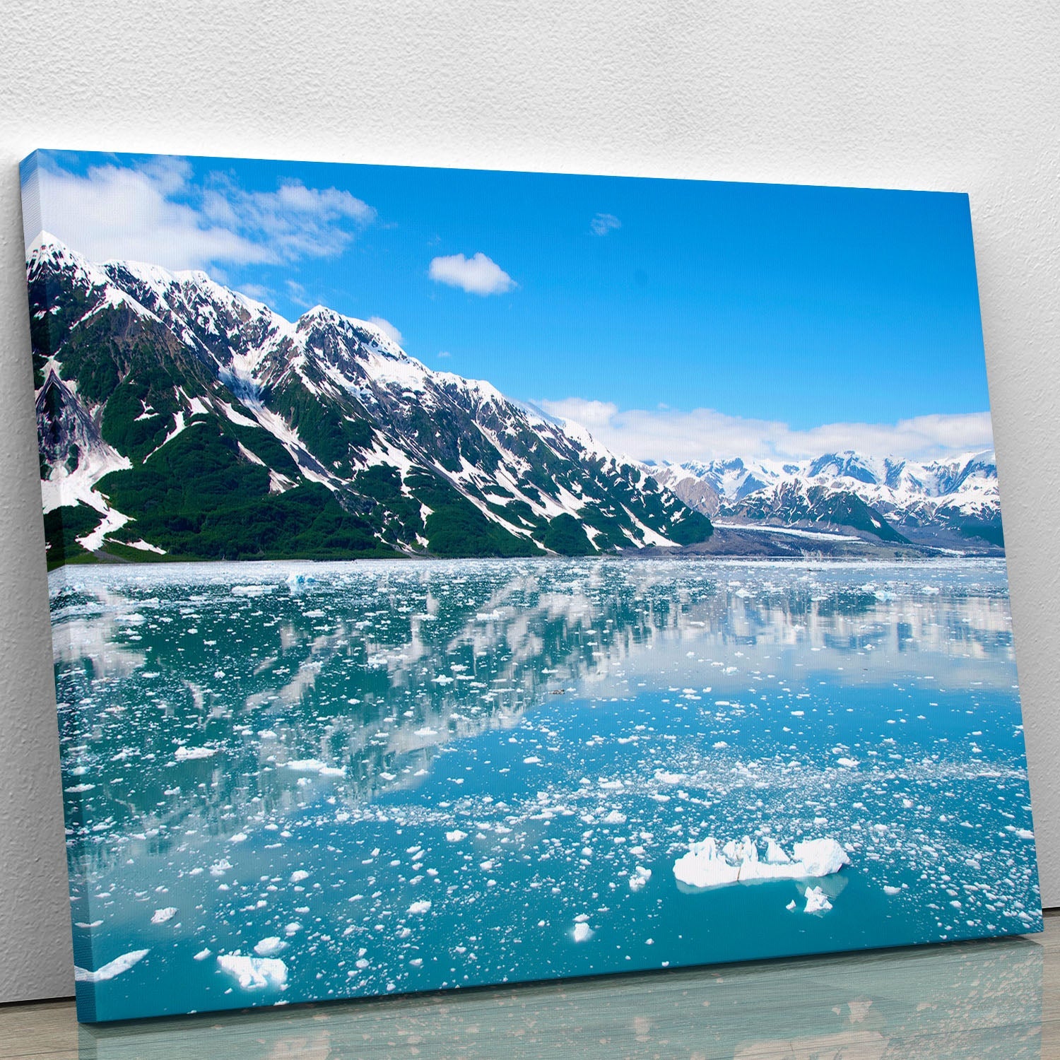 A stunning canvas print of Alaska's breathtaking landscape featuring mountains, forests, and a serene sky.