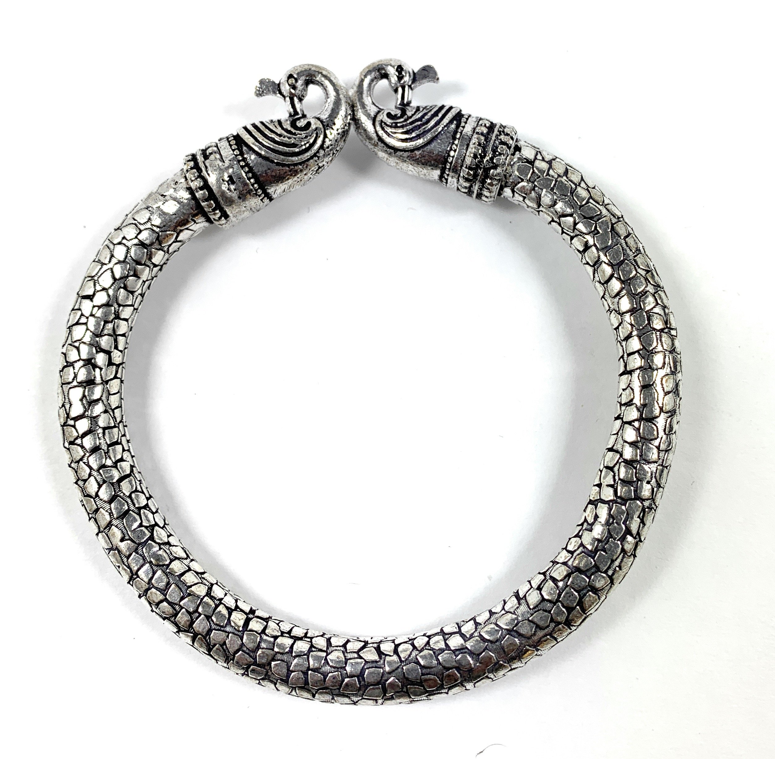 Antique Norse Bracelet featuring intricate peacock heads and snake pattern, showcasing vintage elegance and handmade craftsmanship.