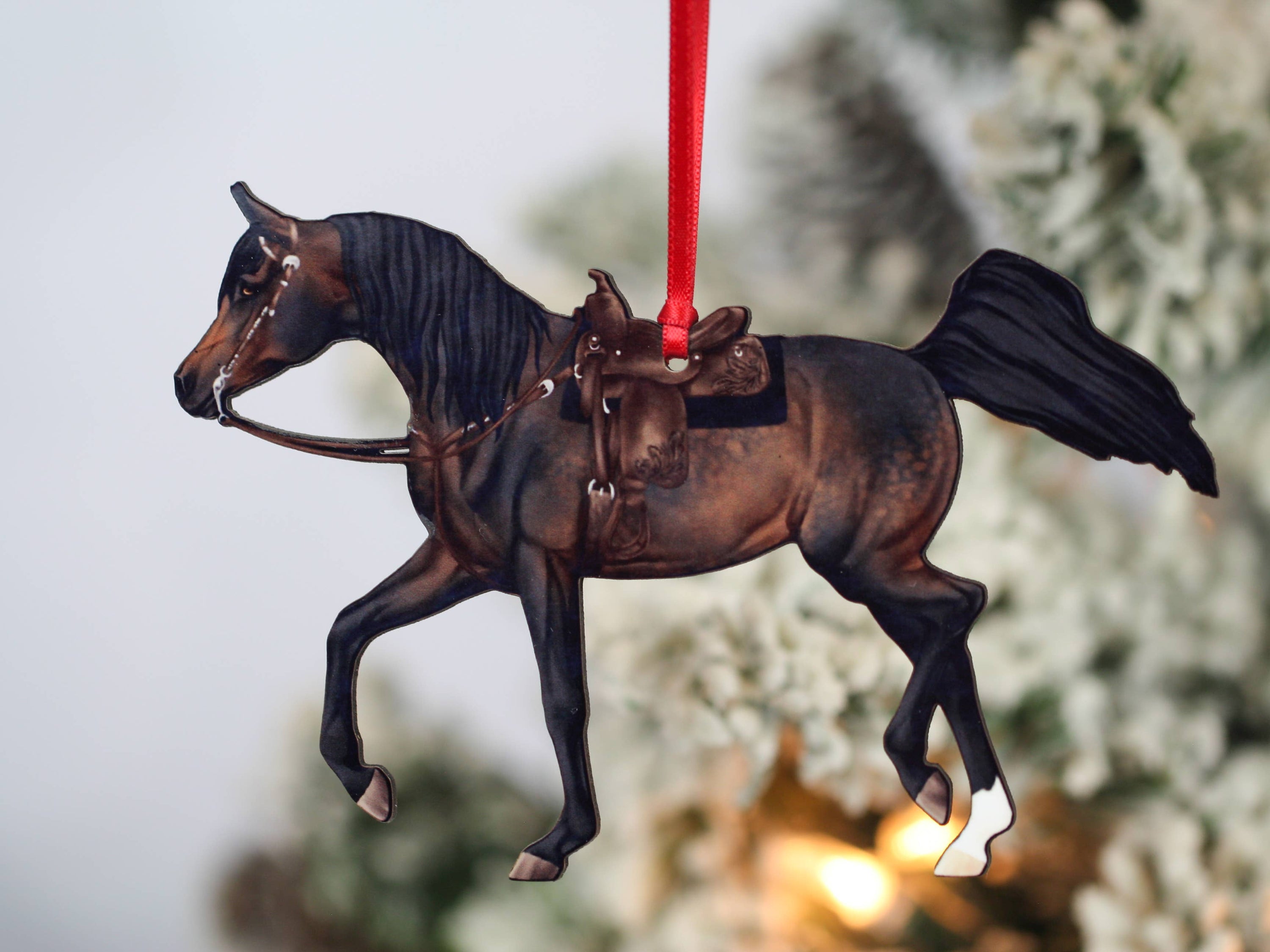 A beautifully crafted Arabian horse ornament in seal bay color, made from composite wood with a glossy finish, perfect for holiday decor.