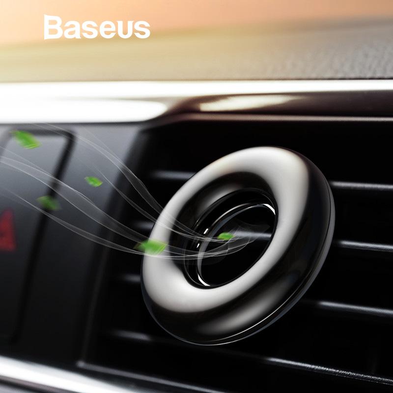 Baseus Aromatherapy Car Phone Holder Air Freshener mounted on a car air vent, showcasing its sleek design and included fragrance options.