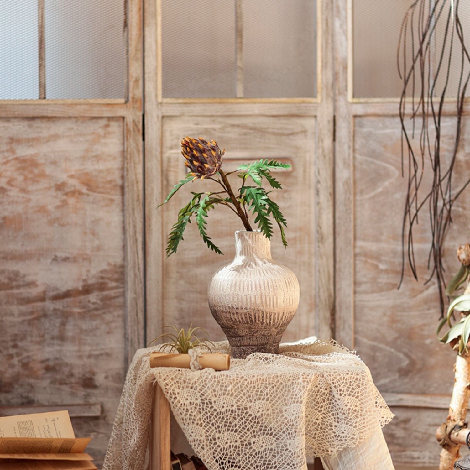 A 21-inch tall artificial artichoke flower stem in rust red, featuring vibrant mixed colors of leaves, perfect for home decor.