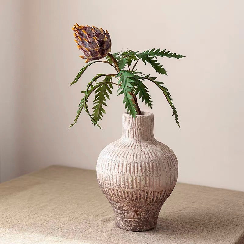 A 21-inch tall artificial artichoke flower stem in rust red, featuring vibrant mixed colors of leaves, perfect for home decor.