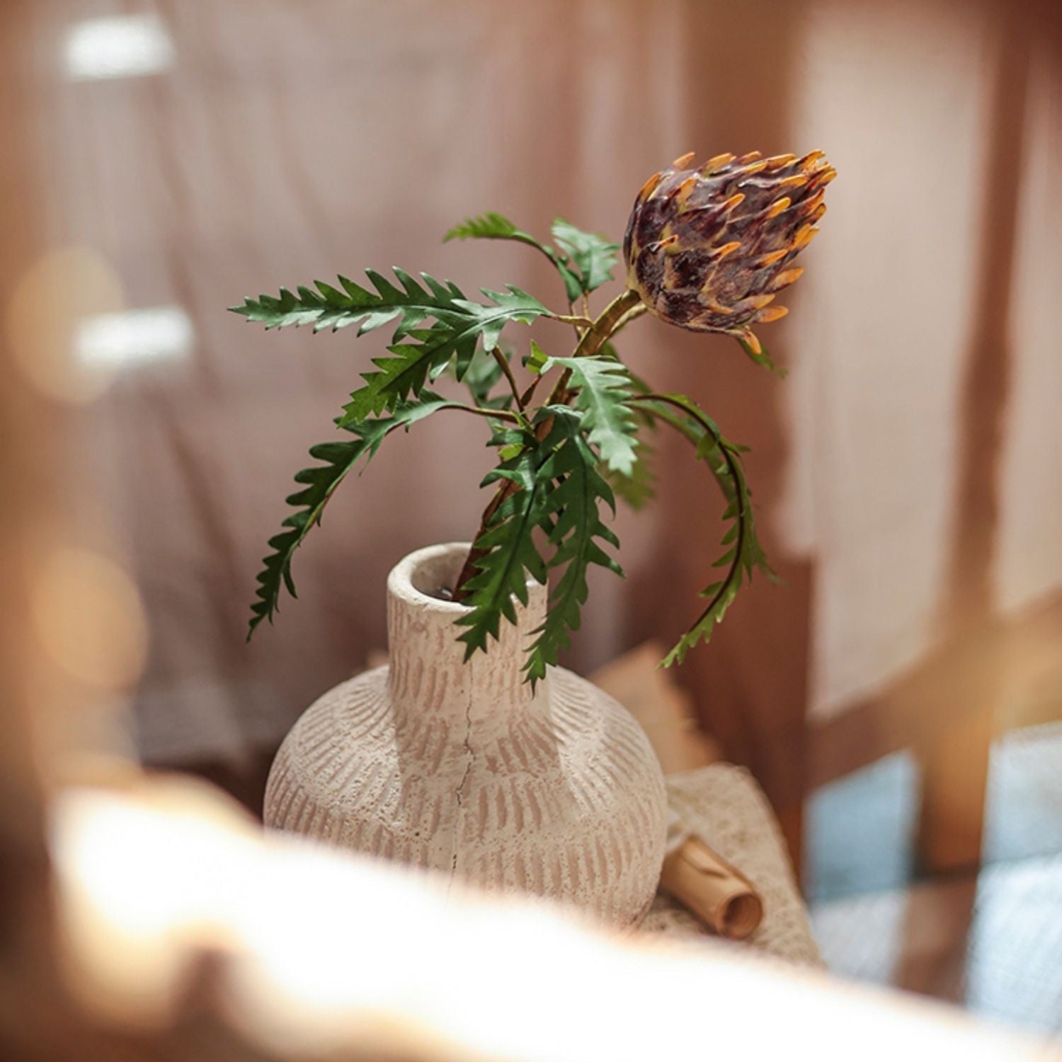 A 21-inch tall artificial artichoke flower stem in rust red, featuring vibrant mixed colors of leaves, perfect for home decor.