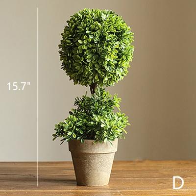 A collection of handmade artificial faux boxwood topiaries in various designs and sizes, showcasing their realistic green foliage.