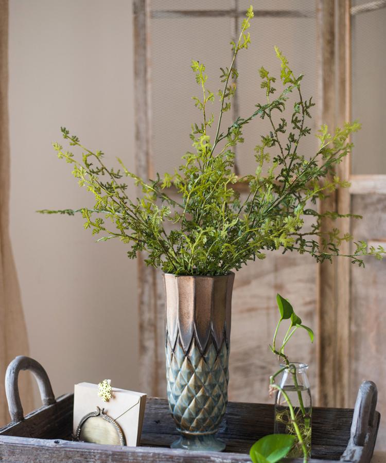 A 25-inch tall artificial faux dancing grass stem in vibrant green, showcasing realistic details and perfect for home decor.