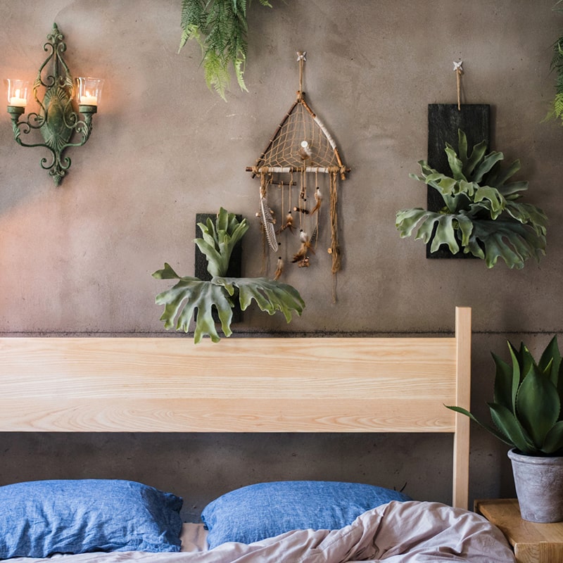 Artificial Faux Fern Madagascar Staghorn mounted on a wooden board, showcasing vibrant green fronds and a rustic brown background.