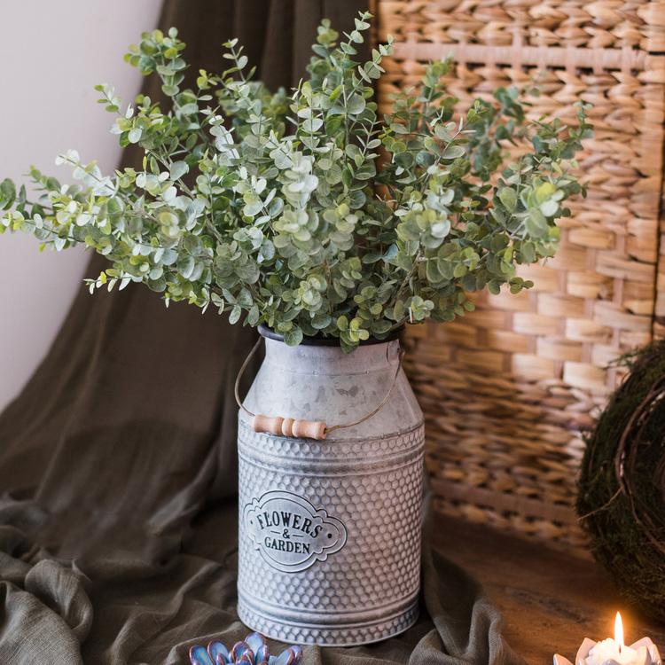 A tall 26-inch artificial eucalyptus stem in vibrant green, showcasing realistic leaves and a slender design, perfect for home decor.