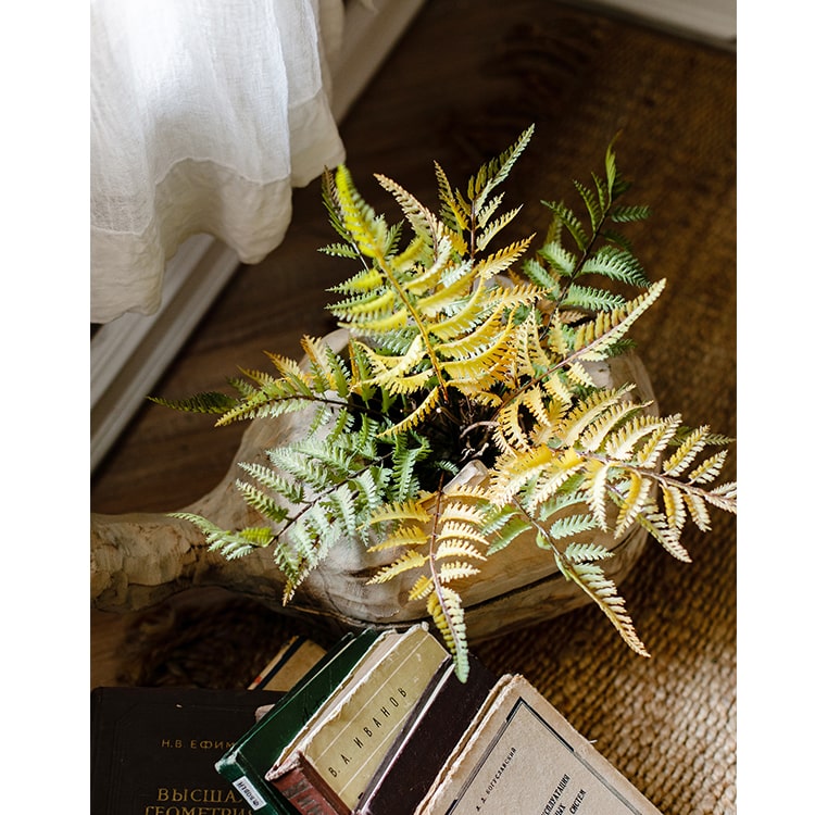 A vibrant artificial fern ball faux plant in fall colors, showcasing green, yellow, and brown hues, perfect for home decor.