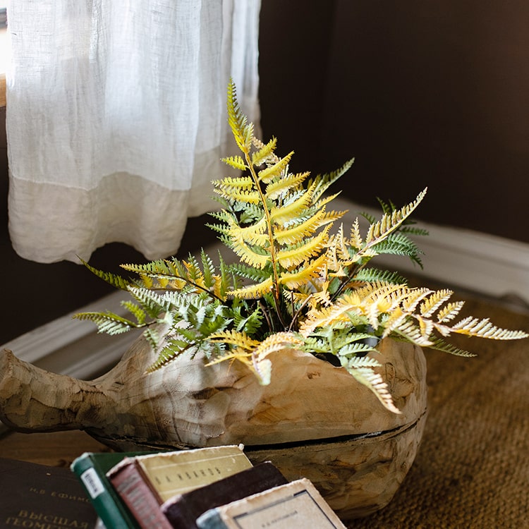 A vibrant artificial fern ball faux plant in fall colors, showcasing green, yellow, and brown hues, perfect for home decor.