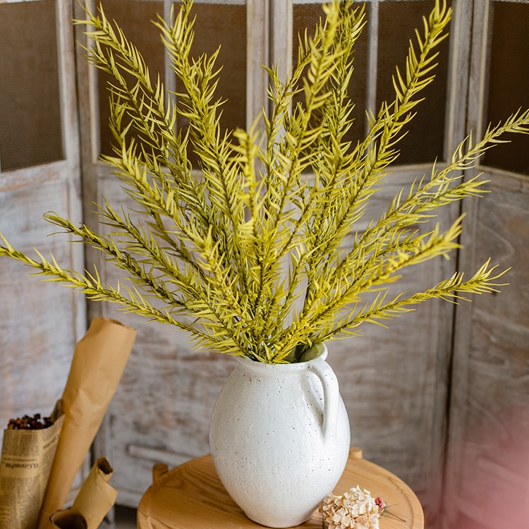 A tall 46-inch yellow artificial flax grass stem, showcasing vibrant color and realistic design, perfect for home decor.