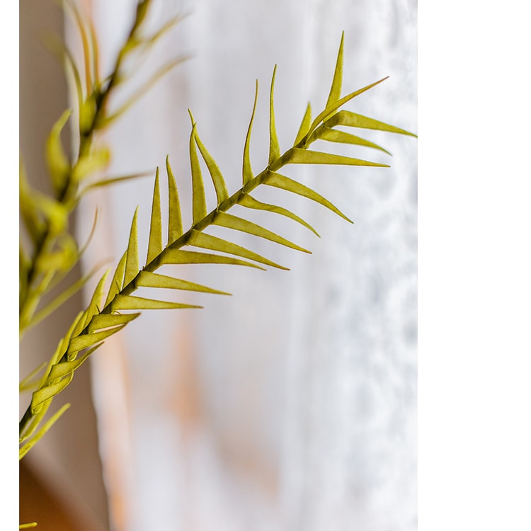 A tall 46-inch yellow artificial flax grass stem, showcasing vibrant color and realistic design, perfect for home decor.