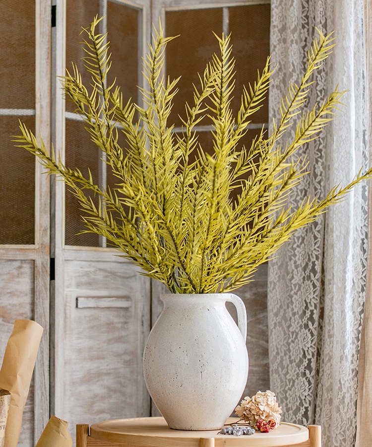 A tall 46-inch yellow artificial flax grass stem, showcasing vibrant color and realistic design, perfect for home decor.