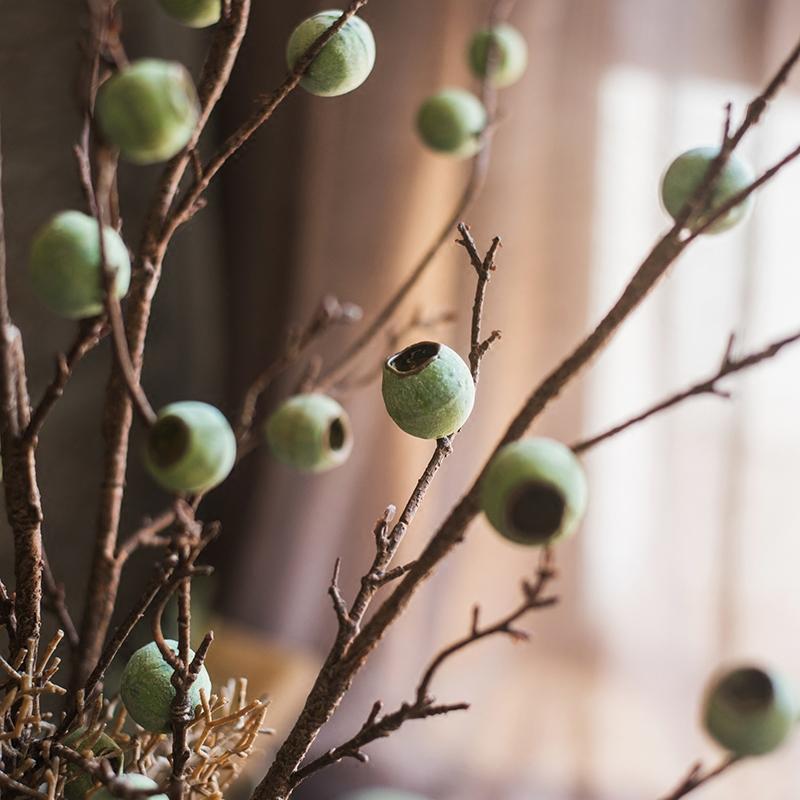 34-inch tall Artificial Kou Li Stem in Green, featuring realistic silk leaves and mixed colors, perfect for home decor.