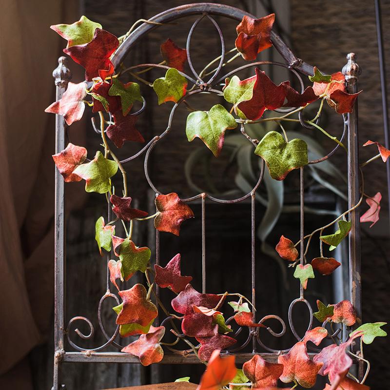 A 43-inch long artificial ivy vine featuring vibrant autumn colors including orange, brown, green, and red, perfect for seasonal decor.