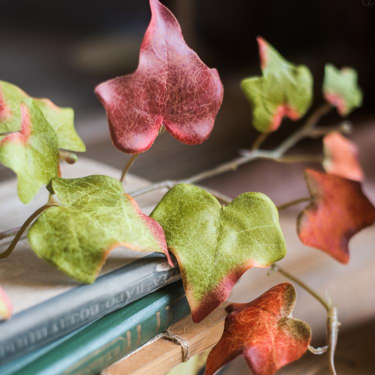 A 43-inch long artificial ivy vine featuring vibrant autumn colors including orange, brown, green, and red, perfect for seasonal decor.