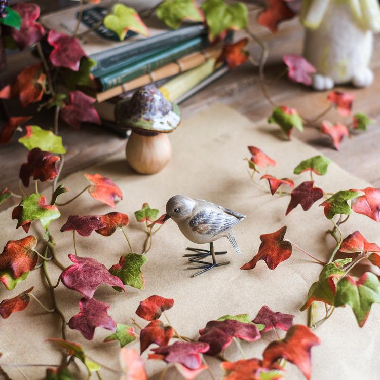 A 43-inch long artificial ivy vine featuring vibrant autumn colors including orange, brown, green, and red, perfect for seasonal decor.