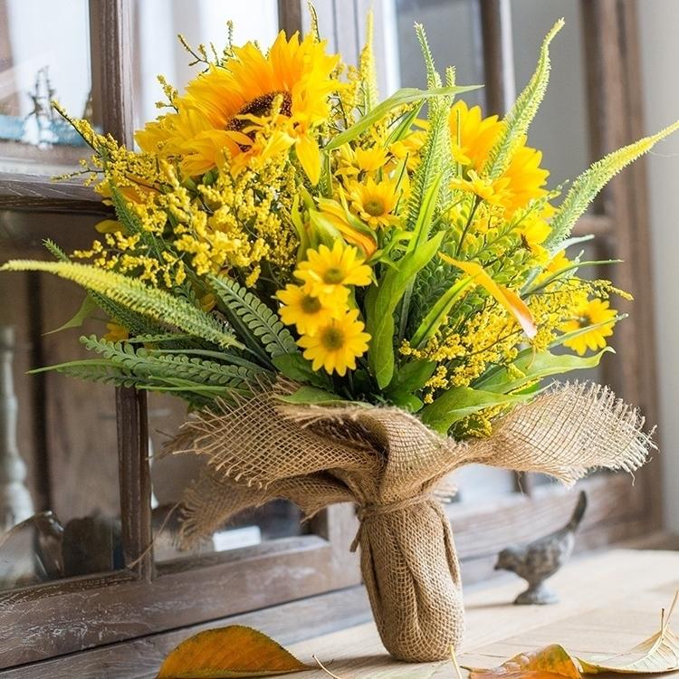 A vibrant 21-inch tall artificial silk sunflower bouquet with lush greenery, showcasing bright yellow flowers in a realistic arrangement.