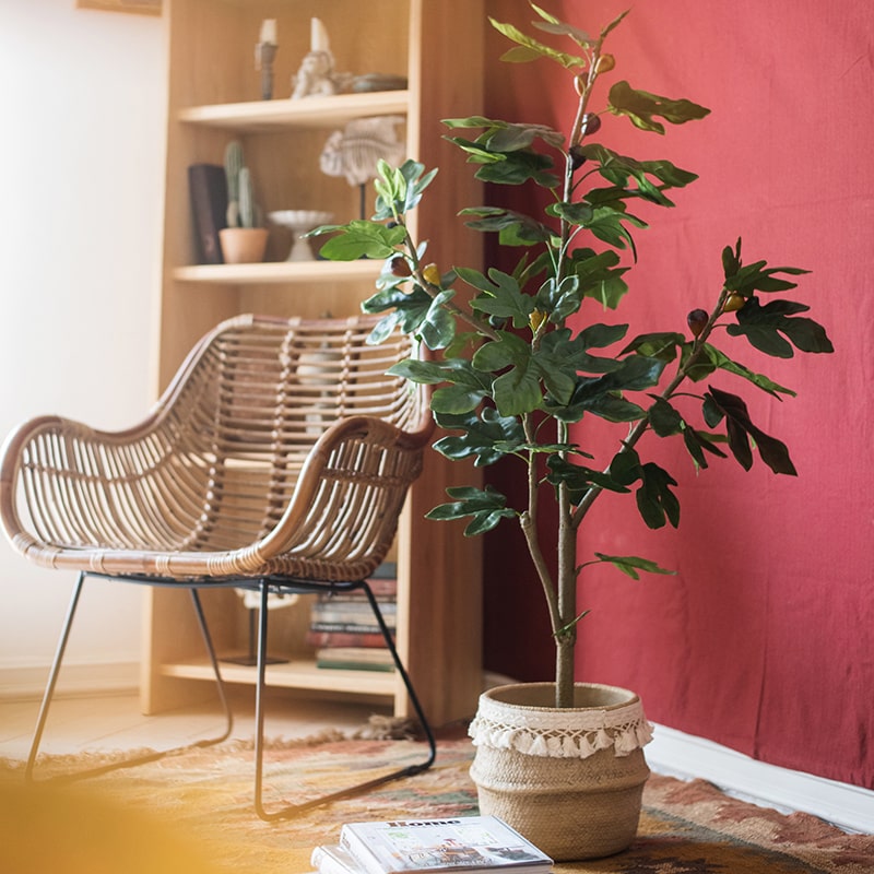 A realistic artificial silk fig tree in a decorative pot, showcasing vibrant green leaves and a lifelike appearance.