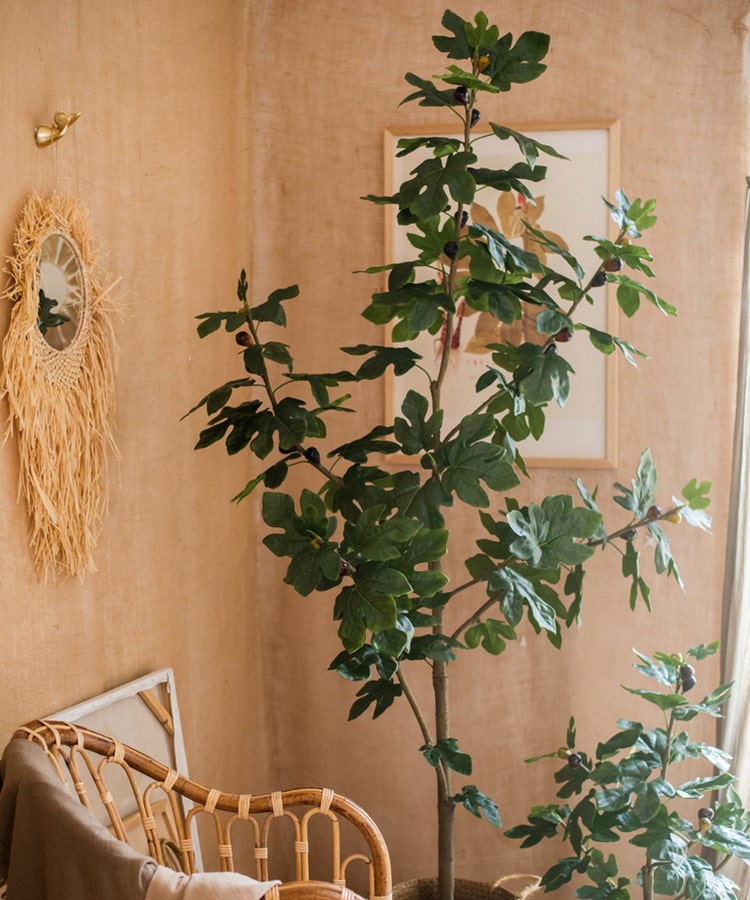 A realistic artificial silk fig tree in a decorative pot, showcasing vibrant green leaves and a lifelike appearance.