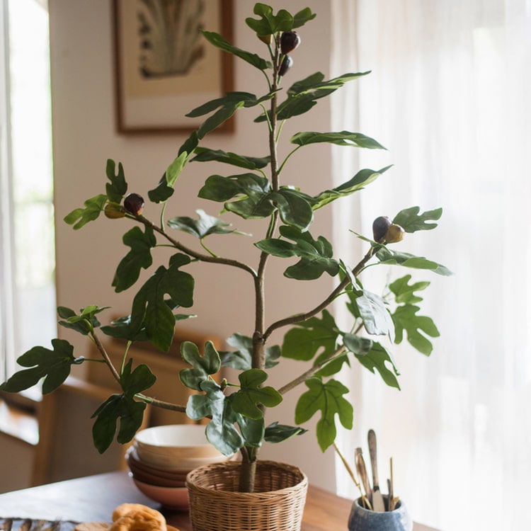 A realistic artificial silk fig tree in a decorative pot, showcasing vibrant green leaves and a lifelike appearance.