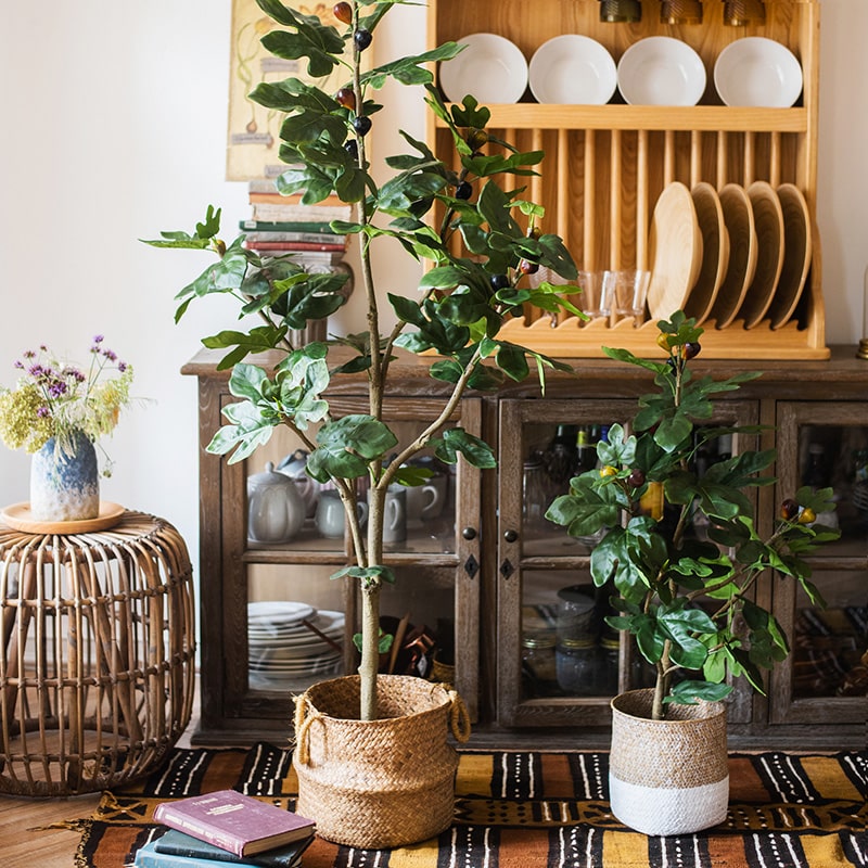 A realistic artificial silk fig tree in a decorative pot, showcasing vibrant green leaves and a lifelike appearance.