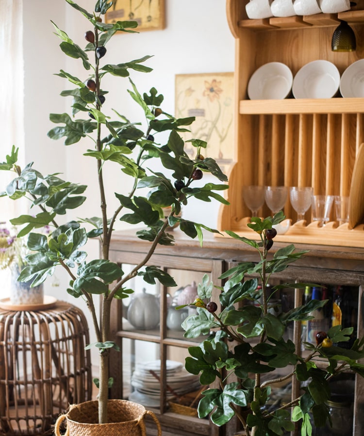 A realistic artificial silk fig tree in a decorative pot, showcasing vibrant green leaves and a lifelike appearance.