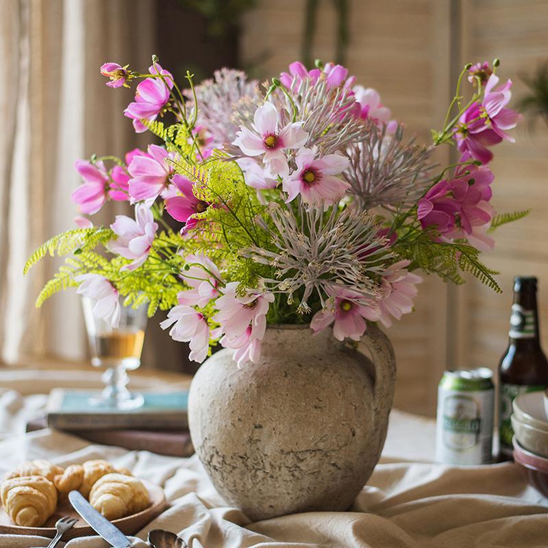 A beautiful 20-inch tall artificial silk flower bouquet featuring vibrant pink daisies and lush greenery, perfect for home decor.