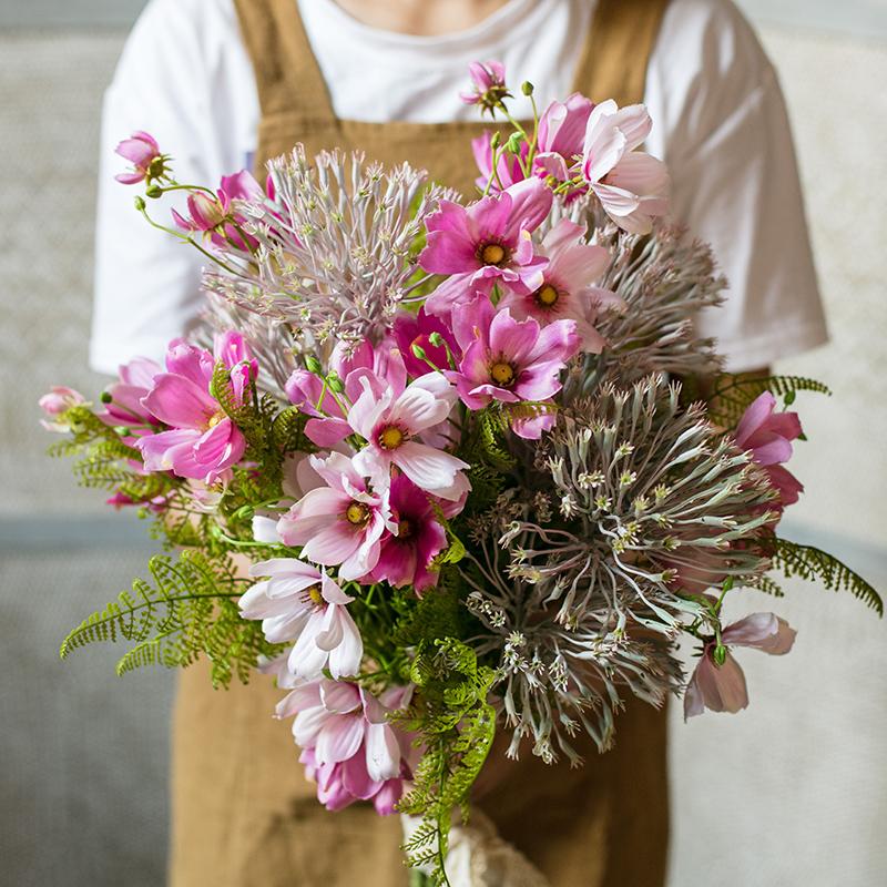 A beautiful 20-inch tall artificial silk flower bouquet featuring vibrant pink daisies and lush greenery, perfect for home decor.