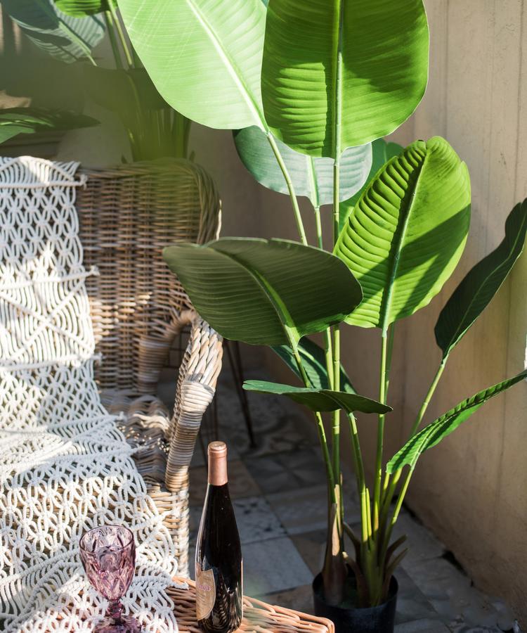 Artificial Silk Travelers Palm Tree in Pot, showcasing lush green leaves and a stylish black pot.