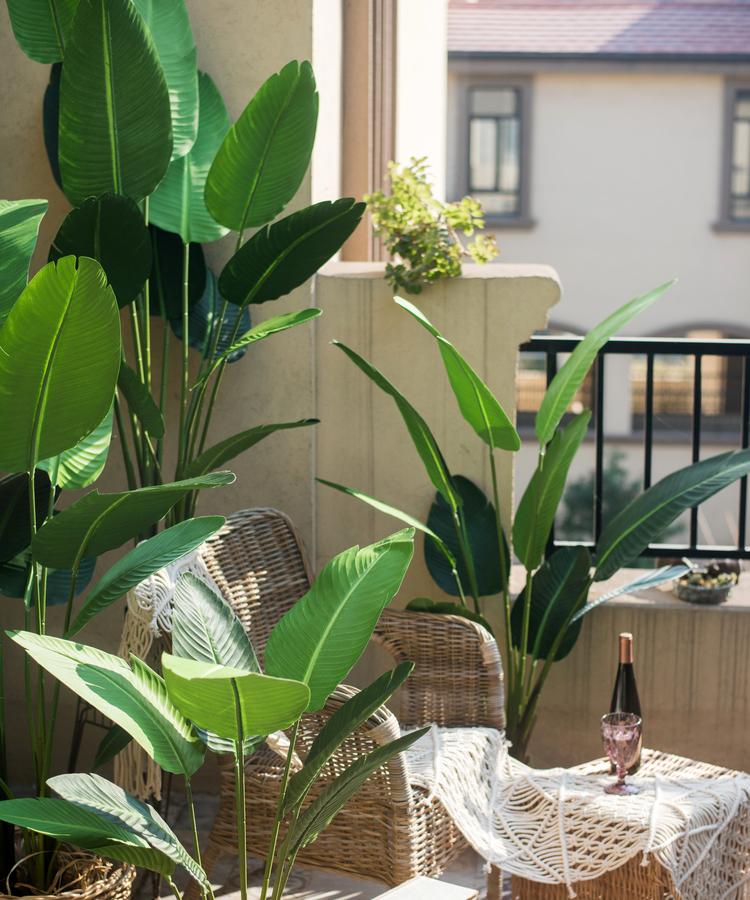 Artificial Silk Travelers Palm Tree in Pot, showcasing lush green leaves and a stylish black pot.