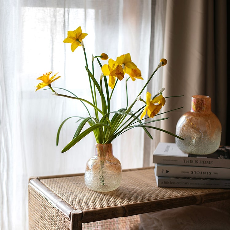 A vibrant 19-inch tall artificial silk yellow daffodil flower stem with two blooms and one bud, featuring realistic green leaves.