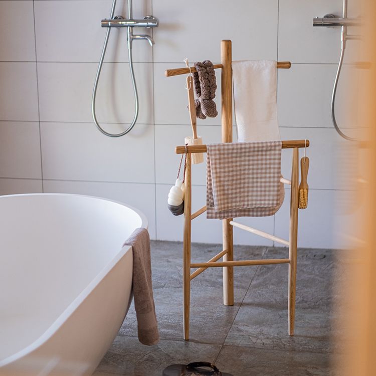 Freestanding Ash Wood Bath Towel Rack in natural color, showcasing unique wood grain and stylish design.