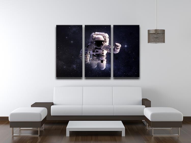 A stunning 3-panel canvas print featuring an astronaut floating in outer space surrounded by stars, perfect for modern decor.