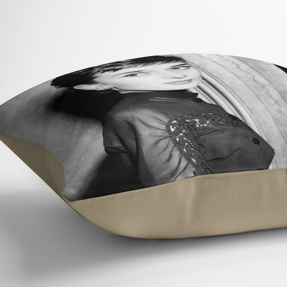 A vibrant abstract cushion featuring Audrey Hepburn's iconic image from 1953, made of luxurious vegan faux suede.