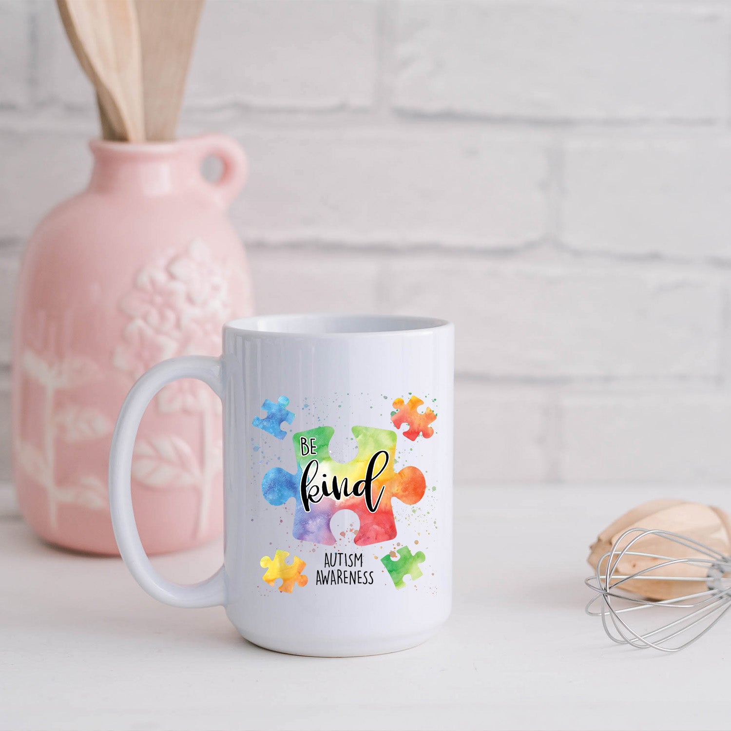 A glossy white 15oz ceramic mug featuring a vibrant Autism Awareness design, perfect for coffee or tea.