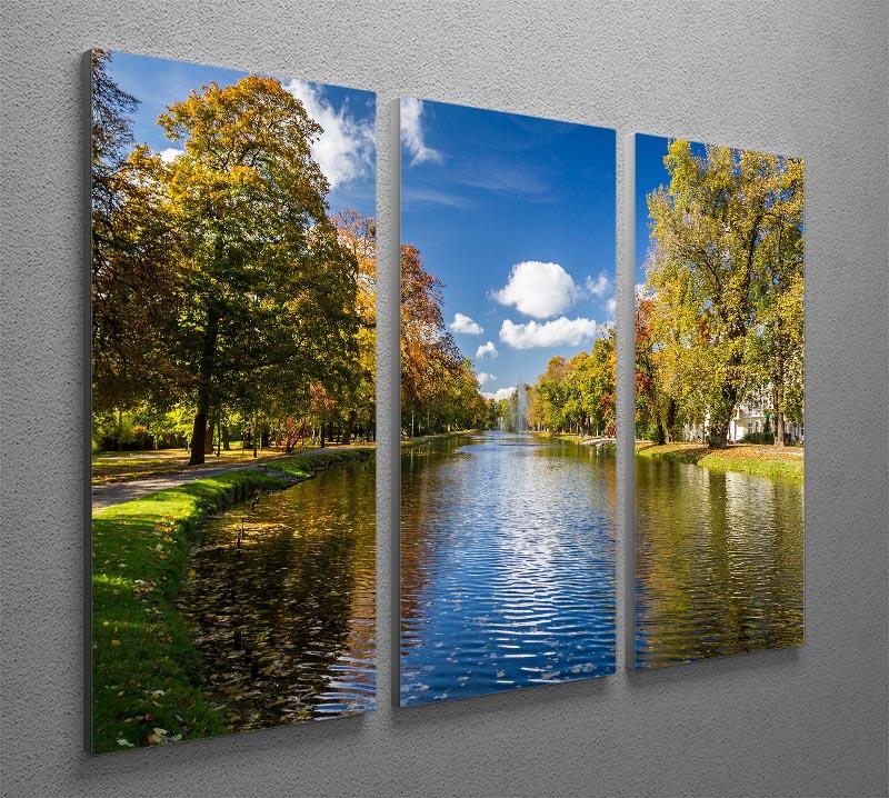 A stunning 3-panel canvas print depicting an autumn park by the river, showcasing vibrant fall colors and serene nature.