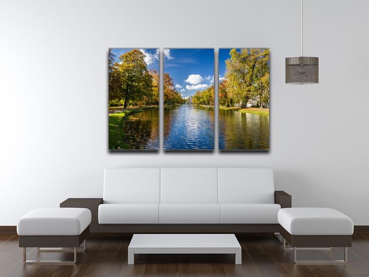 A stunning 3-panel canvas print depicting an autumn park by the river, showcasing vibrant fall colors and serene nature.