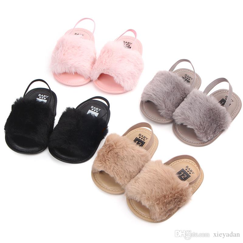 A pair of soft faux fur baby sandals for girls, featuring an anti-slip sole and a stylish design, perfect for summer outings.