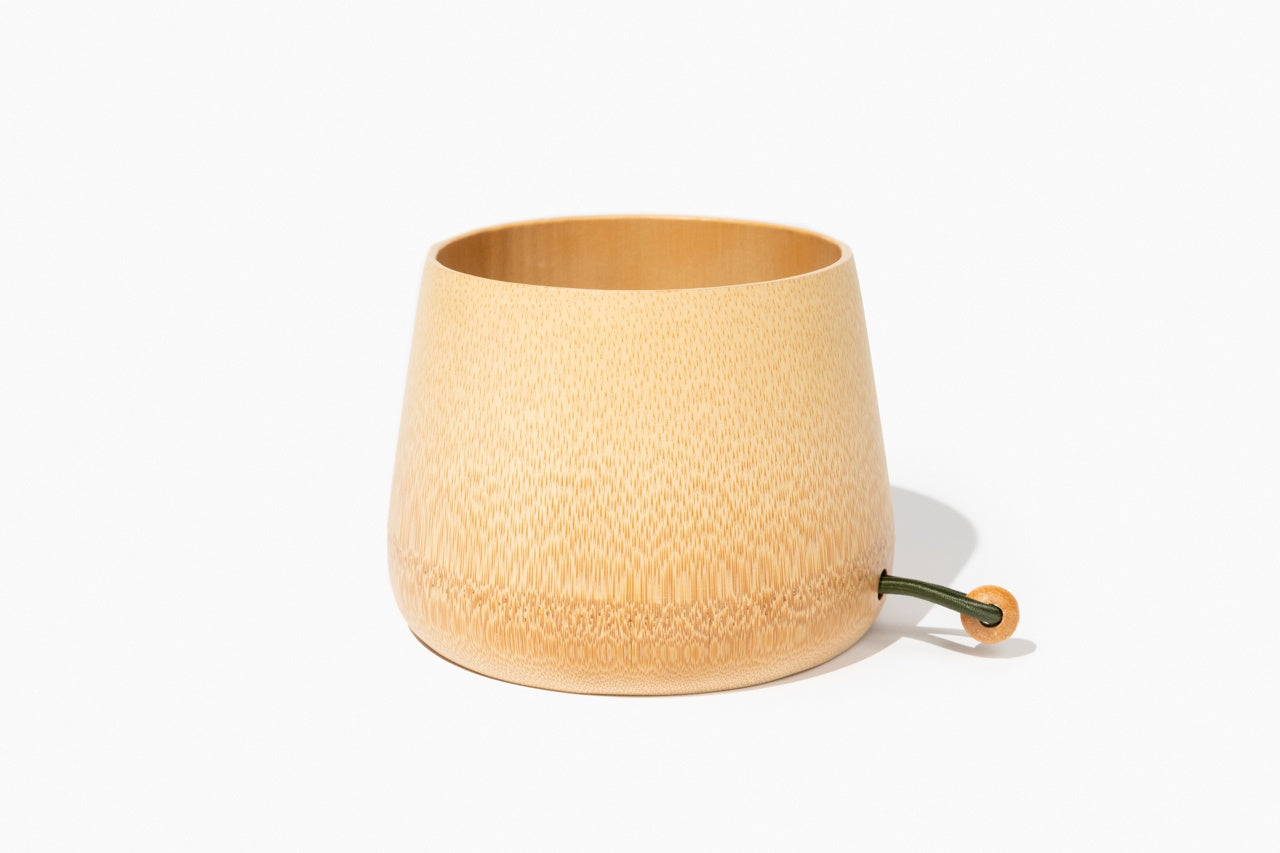 A beautifully handcrafted bamboo salad bowl made from a single sheath of bamboo, showcasing its natural grain and elegant design.