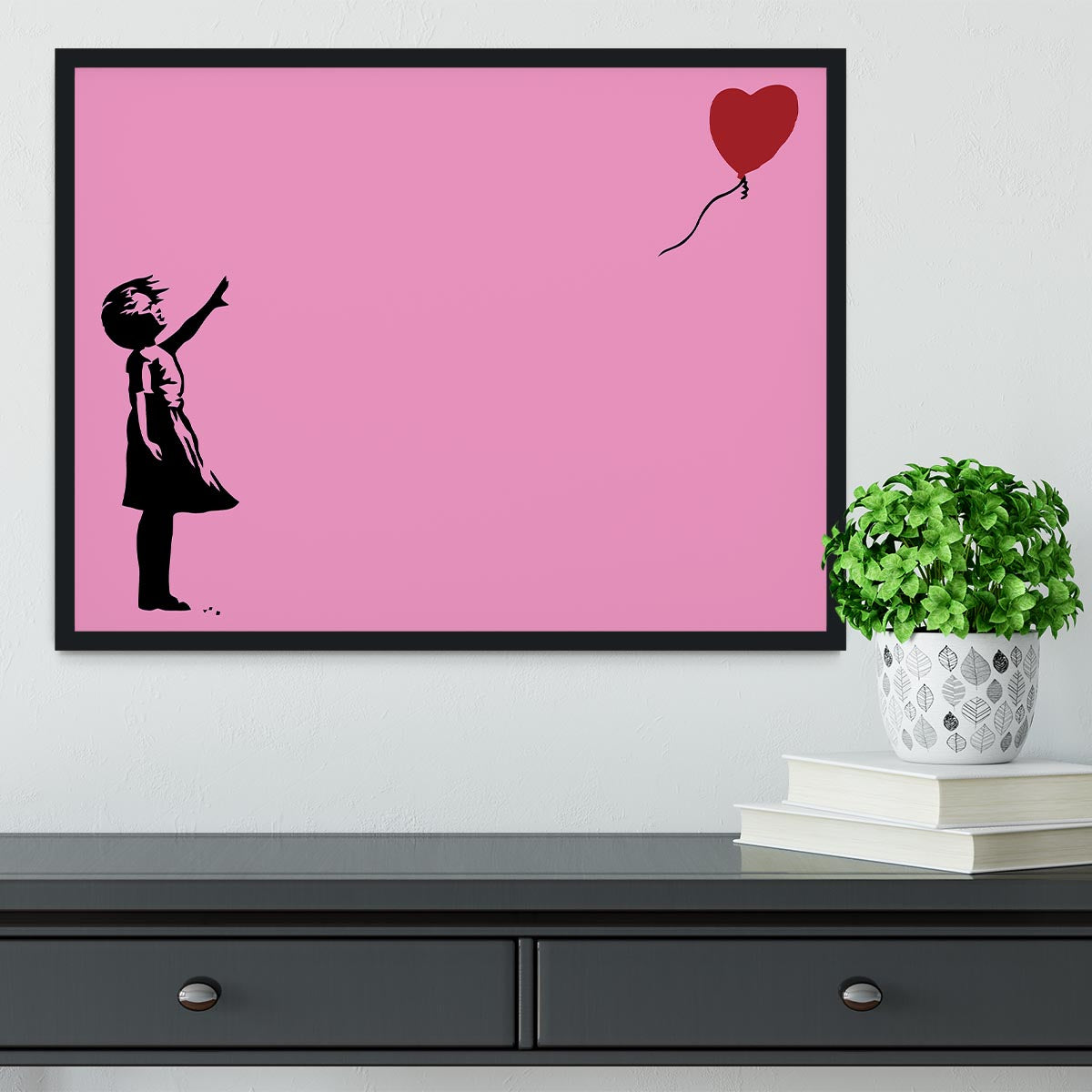 Banksy Balloon Heart Girl Pink Framed Print showcasing a girl reaching for a heart-shaped balloon, framed in a stylish handmade frame.