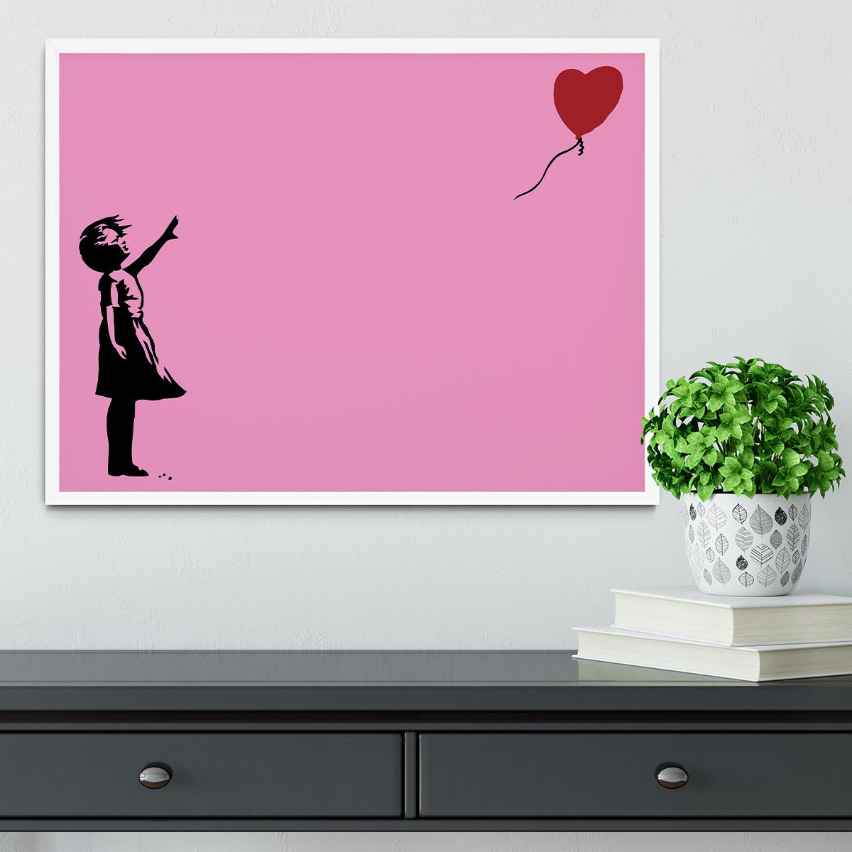 Banksy Balloon Heart Girl Pink Framed Print showcasing a girl reaching for a heart-shaped balloon, framed in a stylish handmade frame.