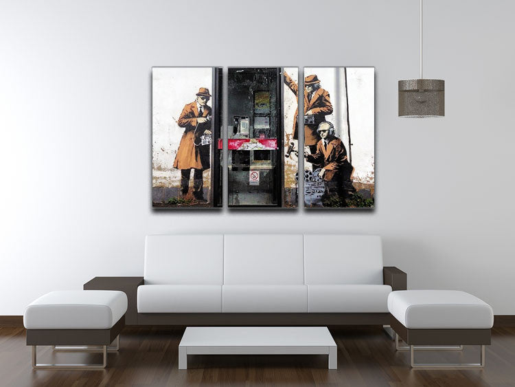 Banksy Cheltenham Telephone Box Spies 3 Split Canvas Print featuring vibrant colors and modern art style across three panels.