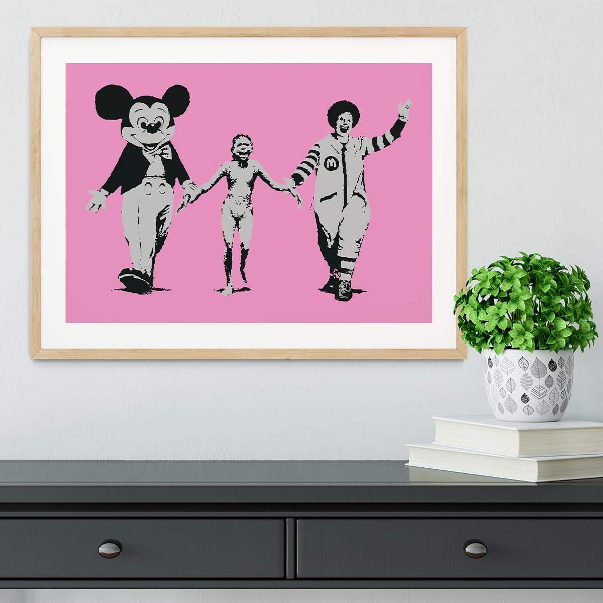 Banksy Mickey and Ronald Pink Framed Print featuring vibrant colors and a stylish handmade frame.